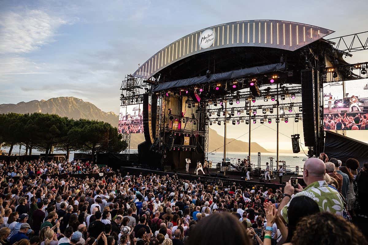 The Lake Stage, framing Lake Geneva (aka Lac Léman), provided an idyllic backdrop for Trombone Shorty's set at the 2024 Montreux Jazz Festival. This year's lineup includes legends like Chaka Khan, Diana Ross, Santana and a tribute to the late, great Quincy Jones. ©Marc Ducrest