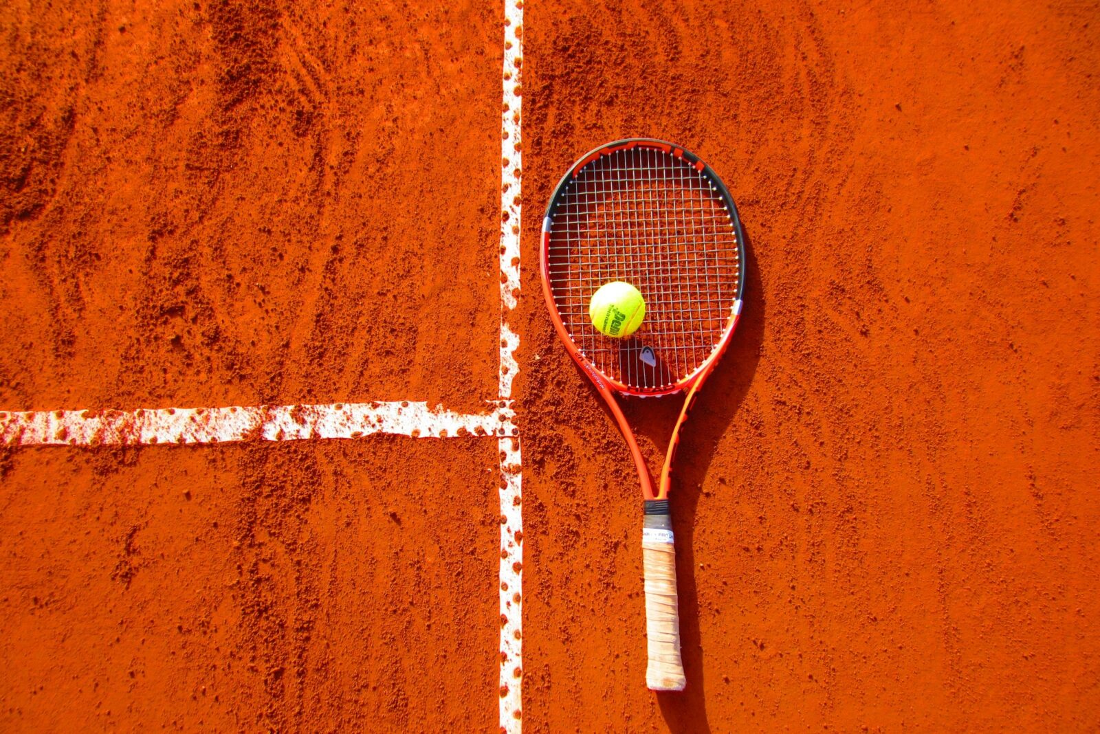 tennis racket on clay course