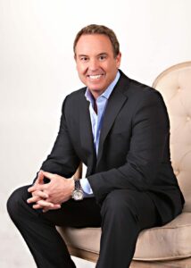 realtor stephen christie sitting on a chair