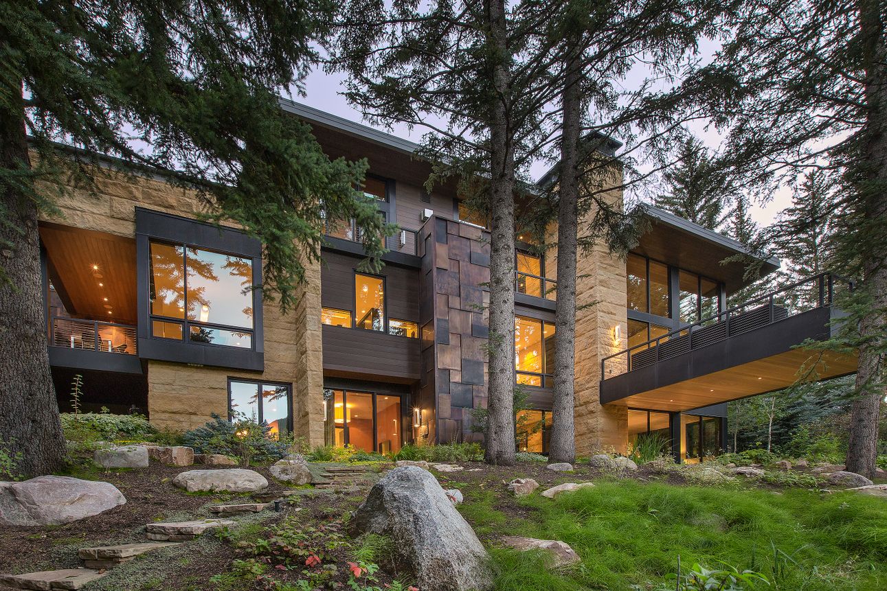 modern luxury home among trees in colorado