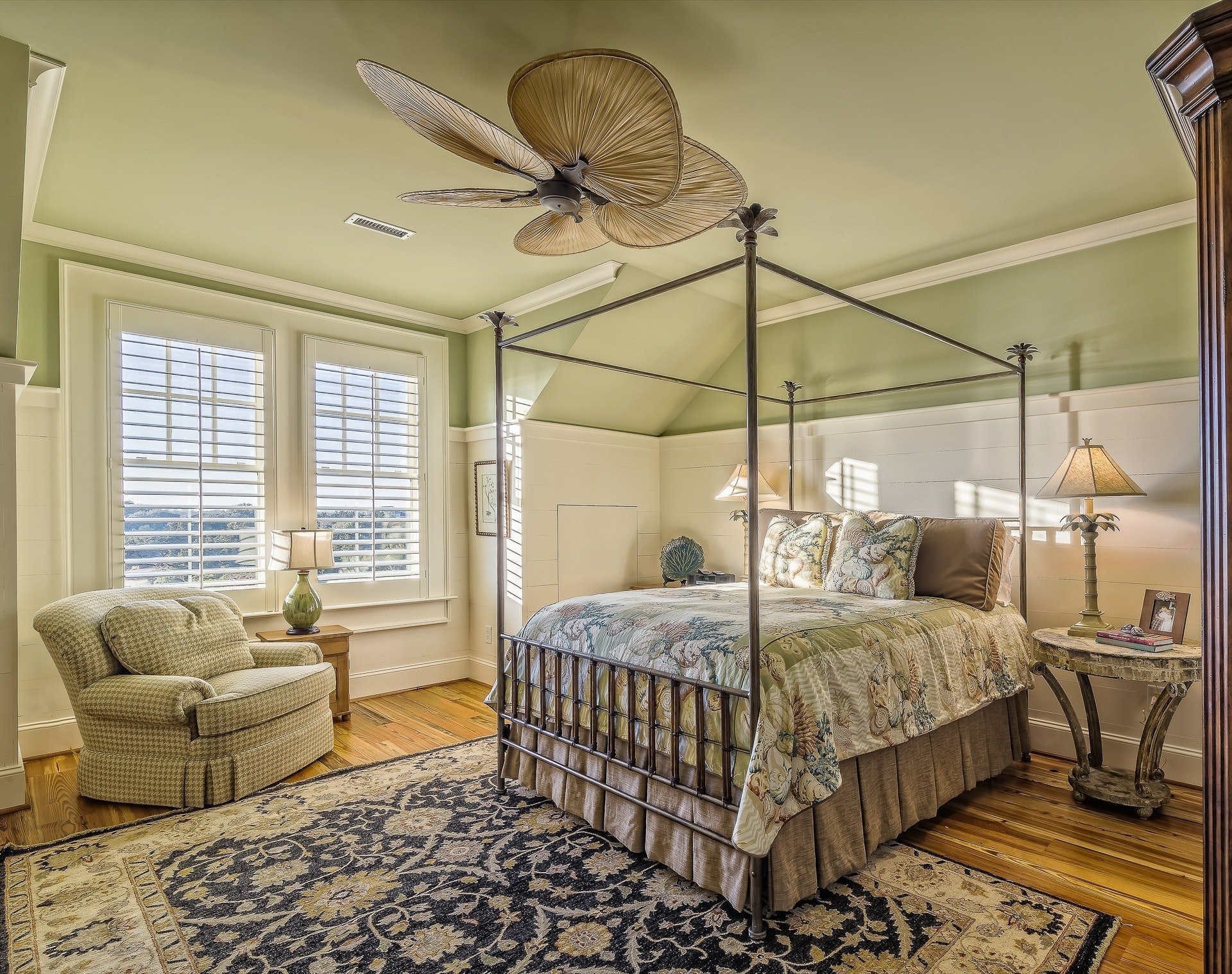 bedroom with light green walls and a four-poster bed