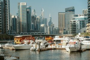 dubai skyline with marina and boats in the foreground