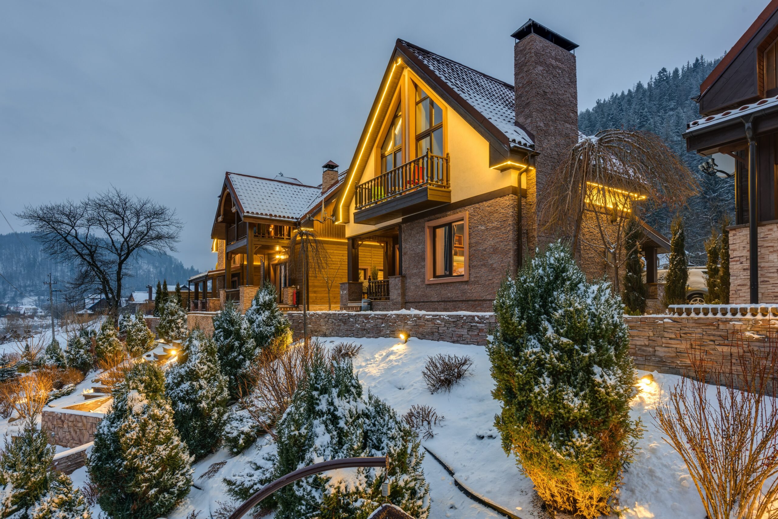 luxury chalet covered in snow at night