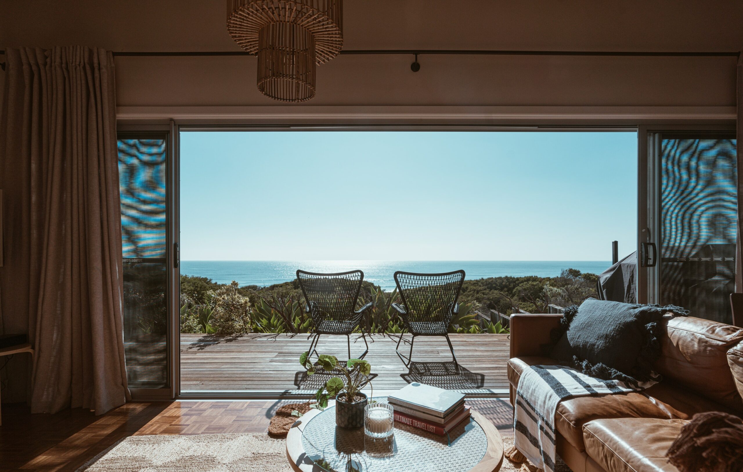 sliding doors looking out towards the ocean from a luxury home in california