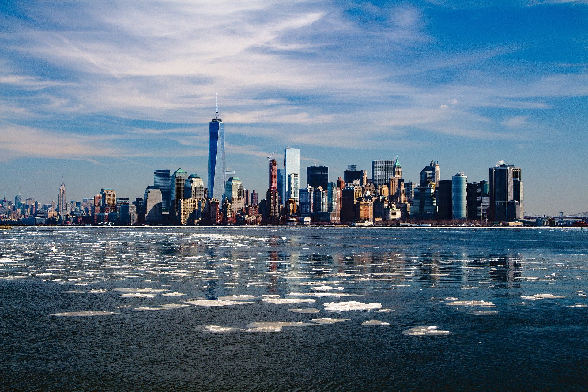 new york city skyline and river with ice