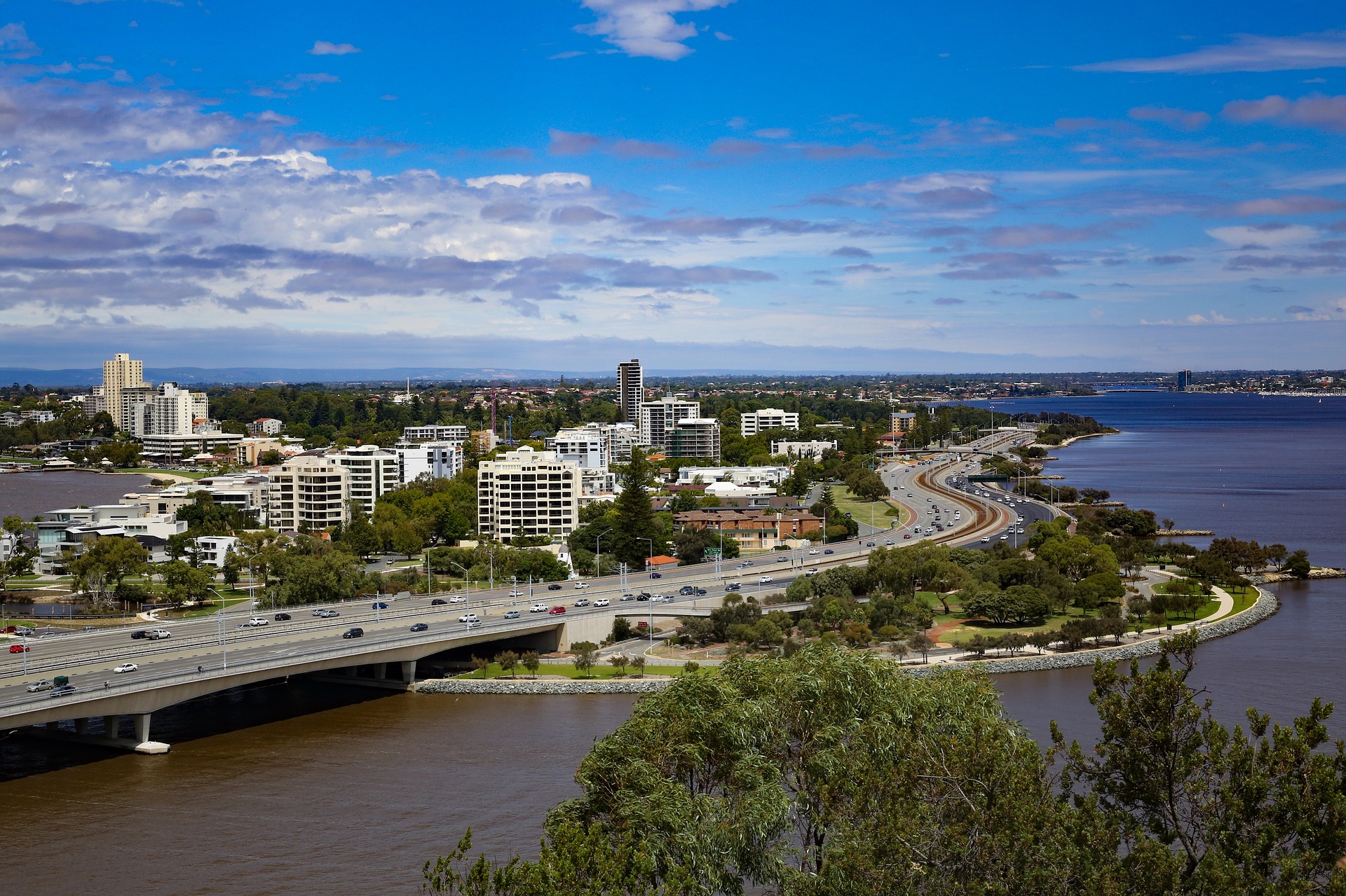 aerial view of perth skyline with buidings and bridge over water