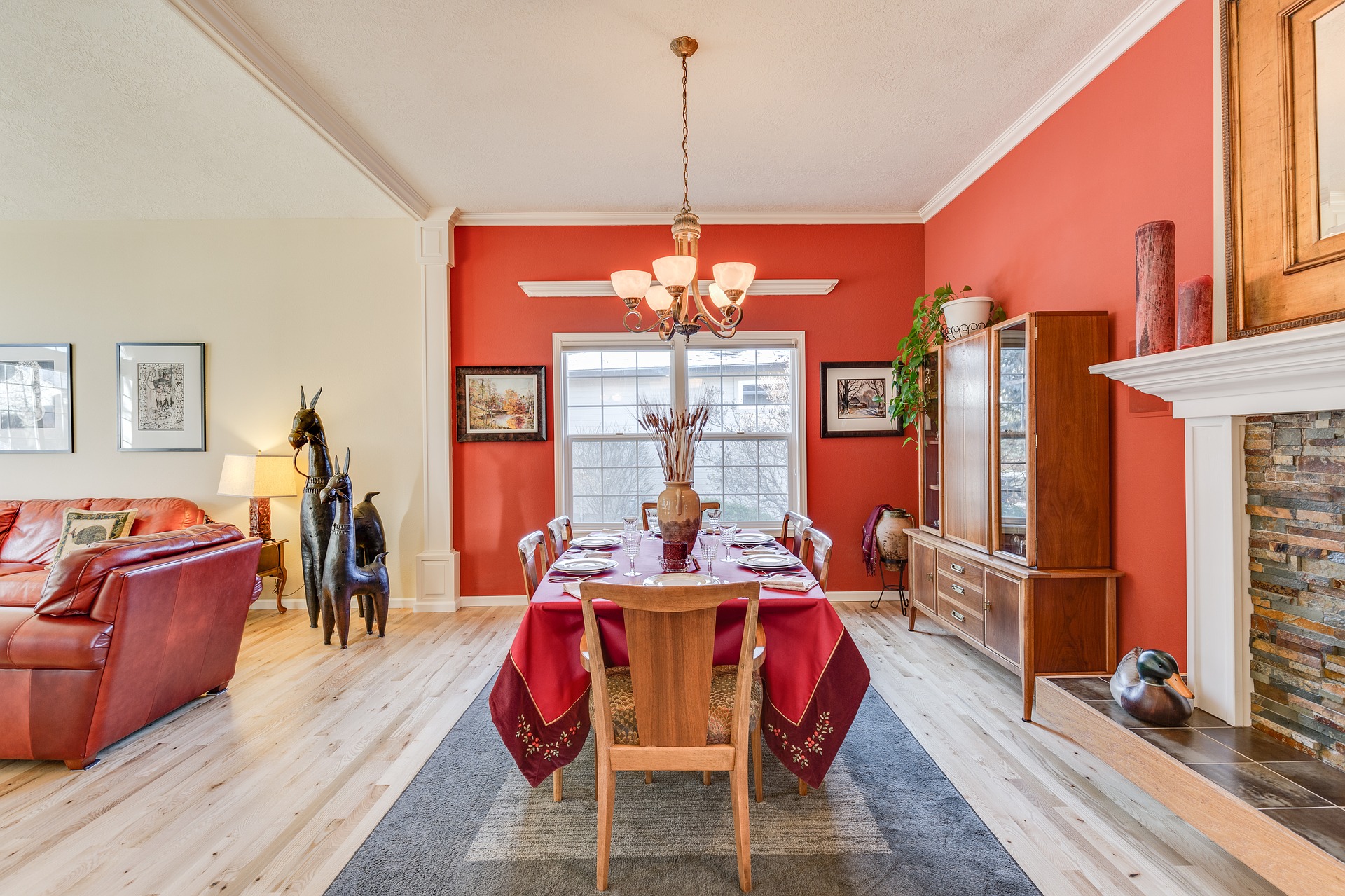 red hued dining room with fireplace and table