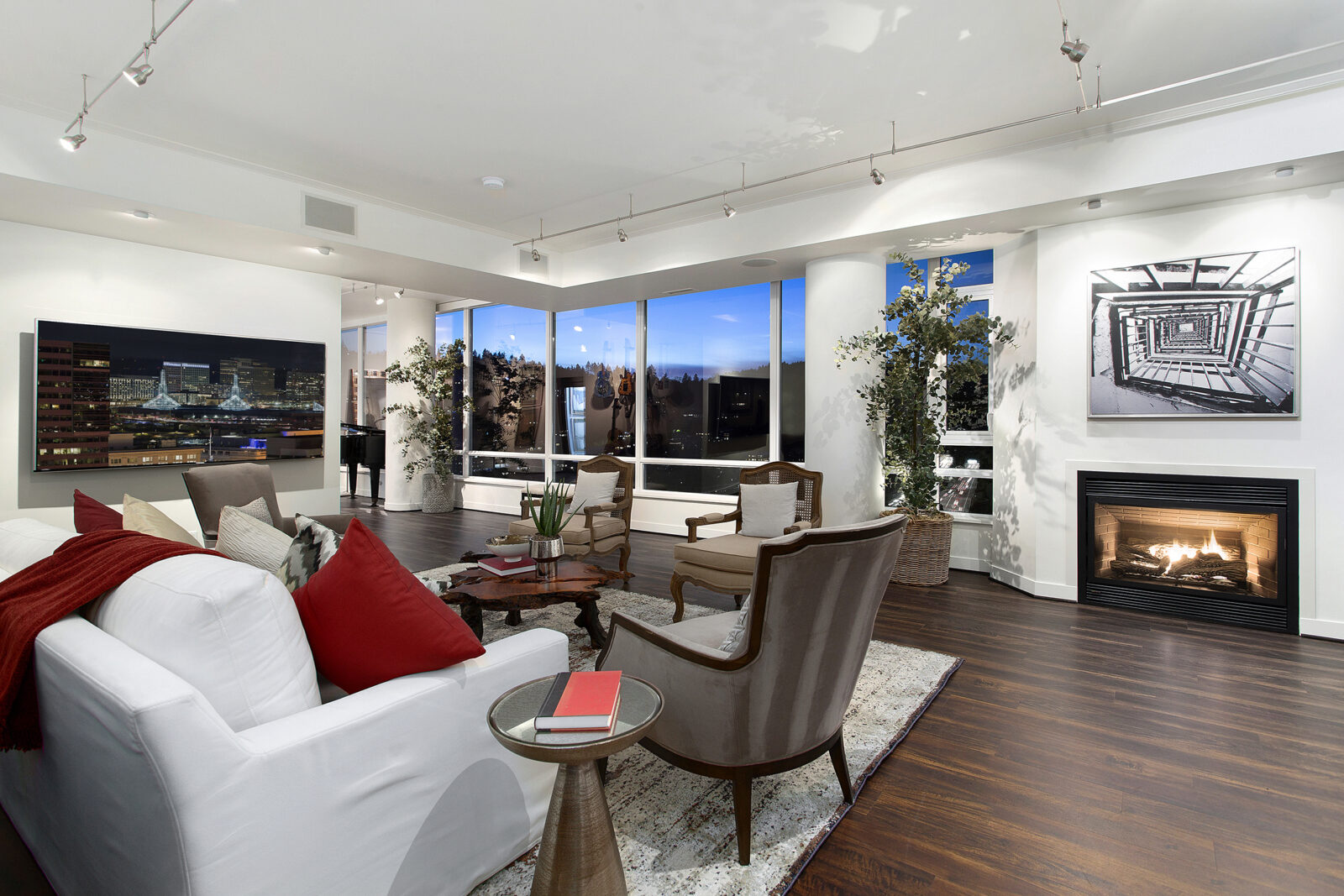Living space in Portland penthouse with fireplace and views of city.