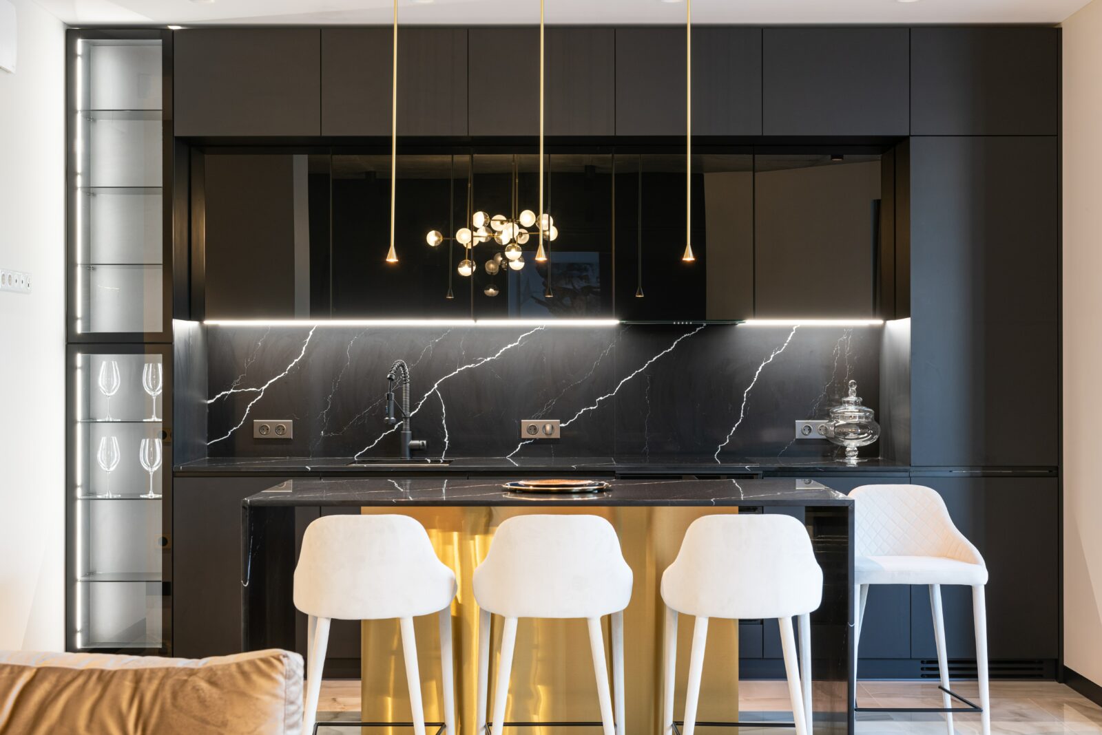 modern kitchen with black marble and gold accents