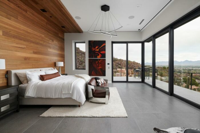 bedroom with walls of windows looking at the desert in arizona