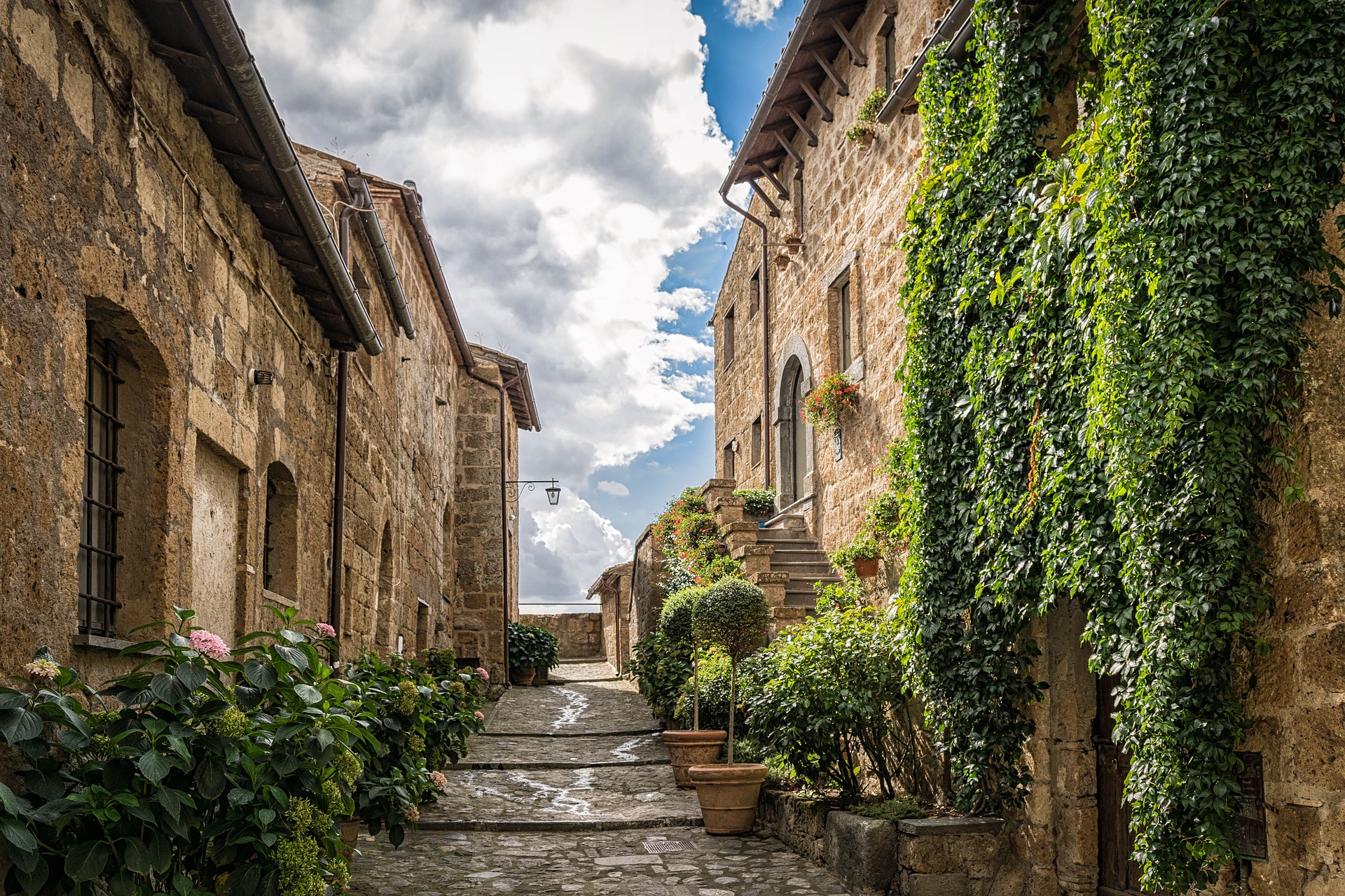 stone path leads up to historic homes in italy