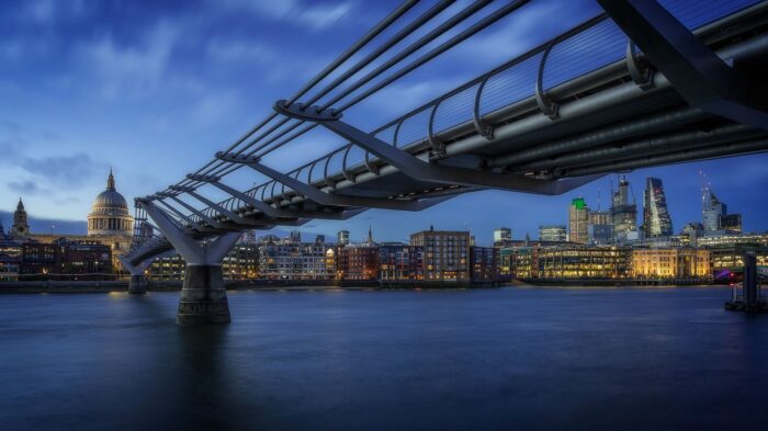 night photo of london skyline and bridge