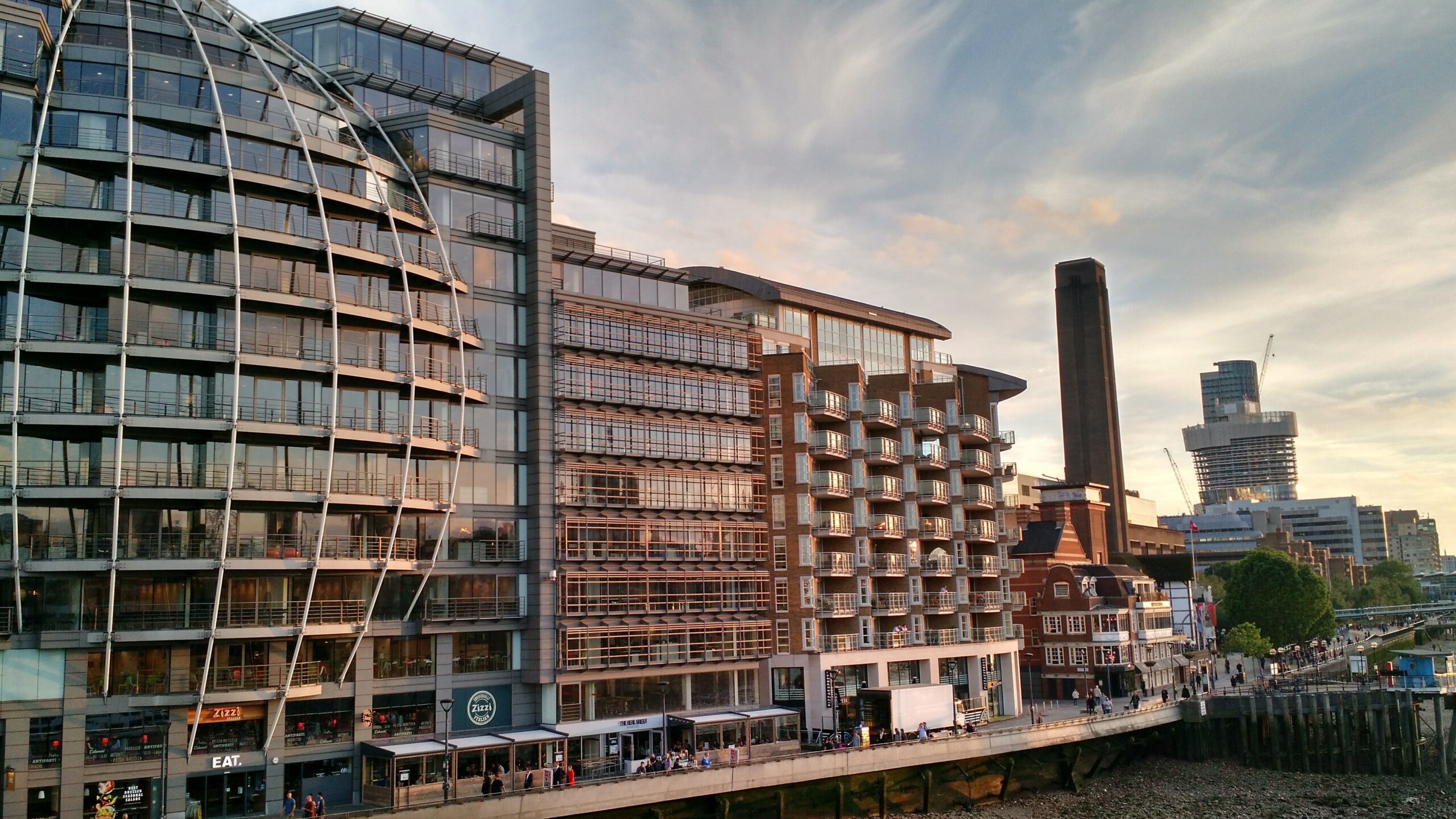 row of modern buildings along the waterfront in london, united kingdom
