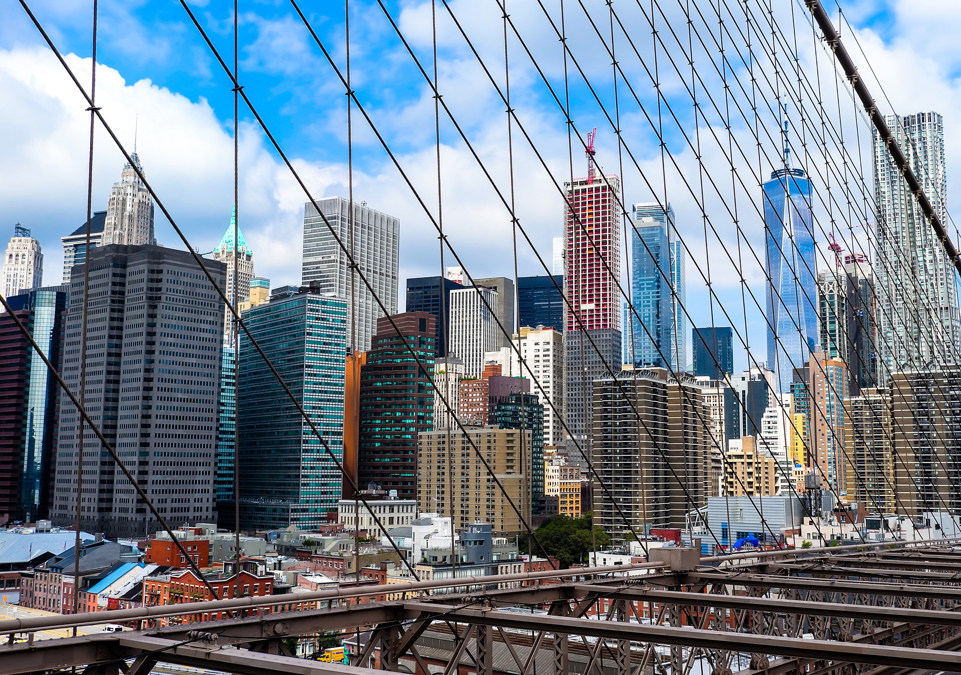 new york skyline looking through bridge suspension