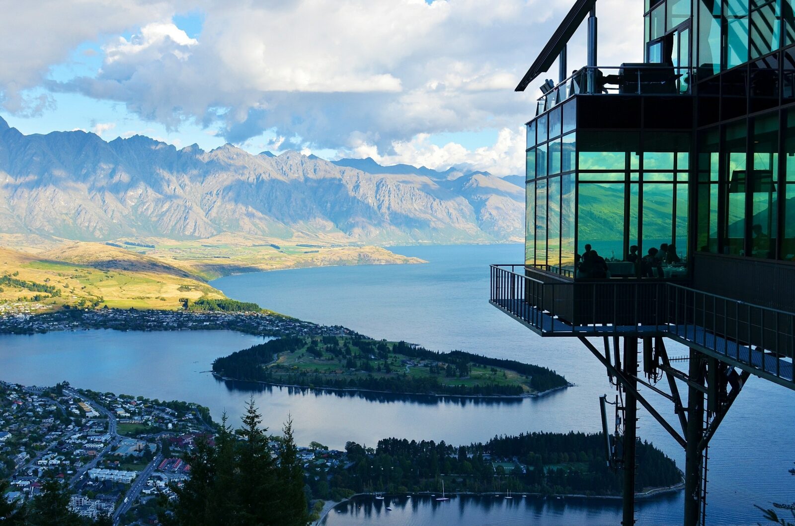 skyline view of new zealand homes from a glass-box architectural marvel atop a mountain
