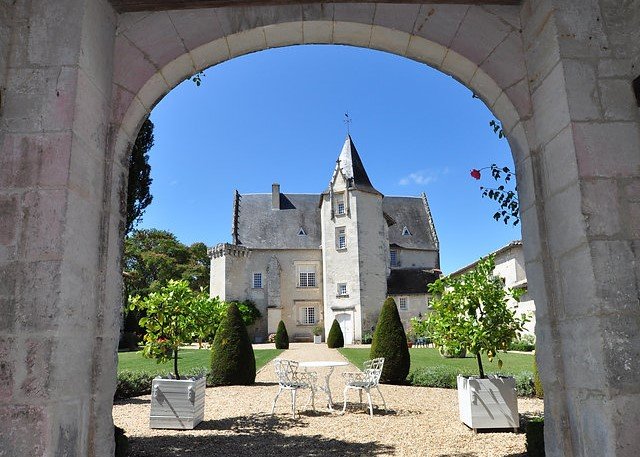 arched entry to a stone chateau in france