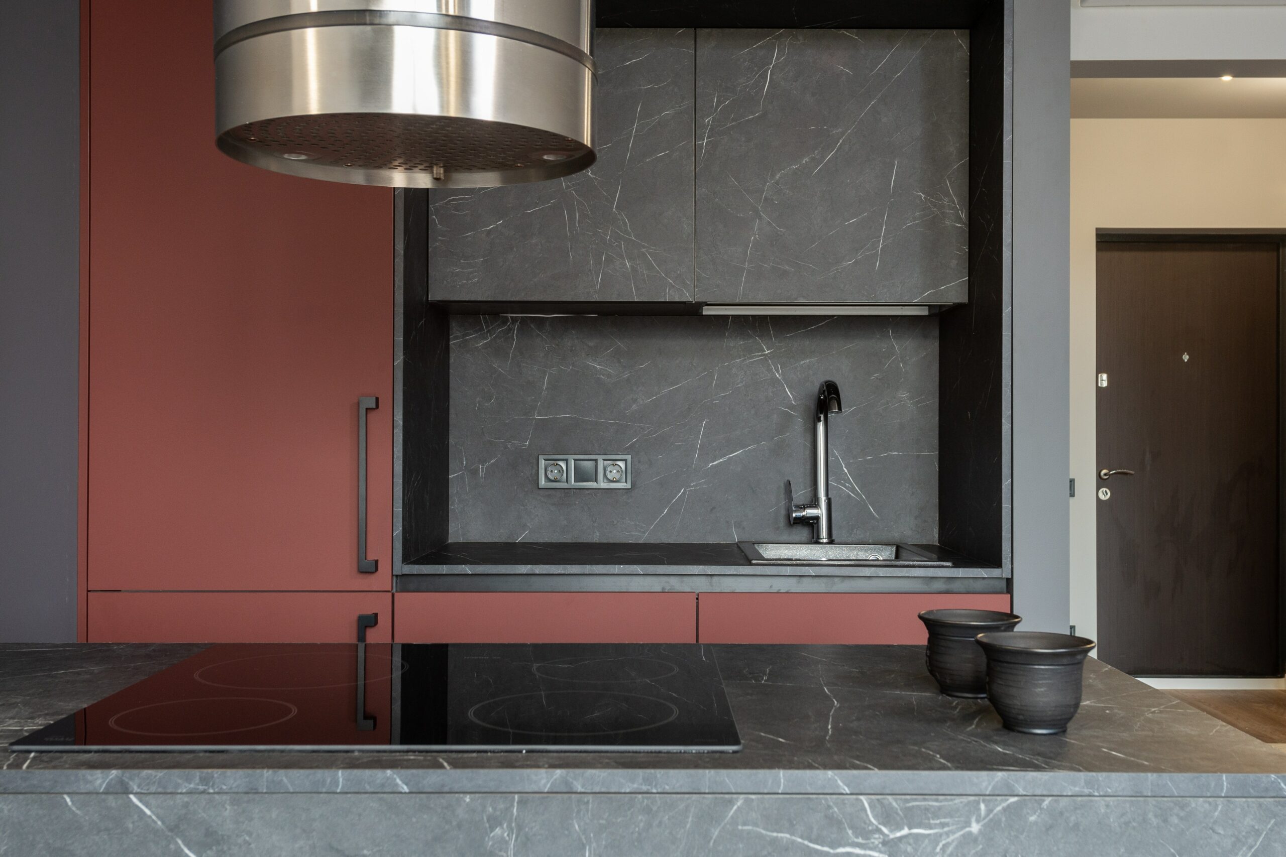 compact modern kitchen with dark granite backsplash and countertops