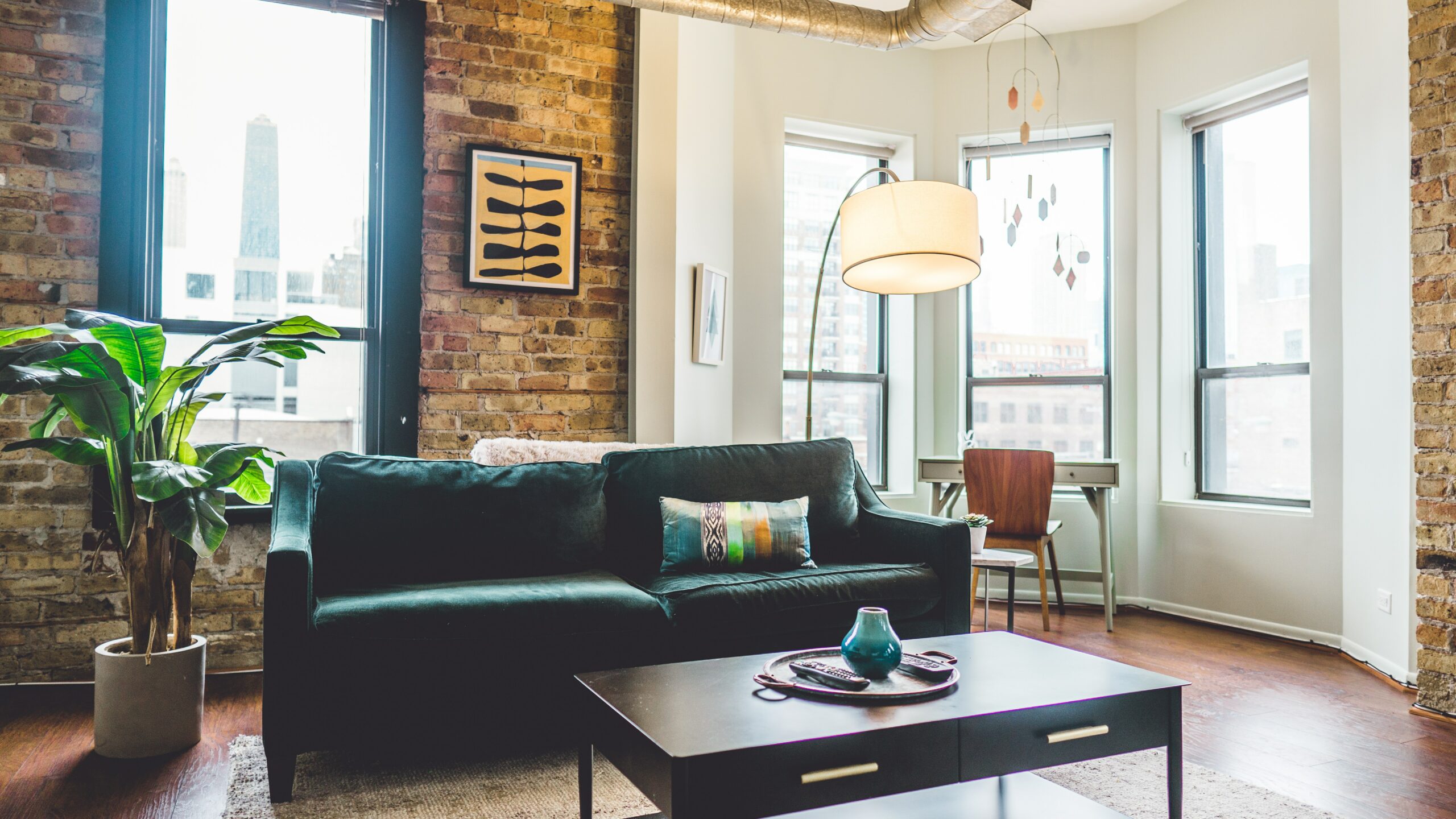 cozy living room with brick walls and large windows