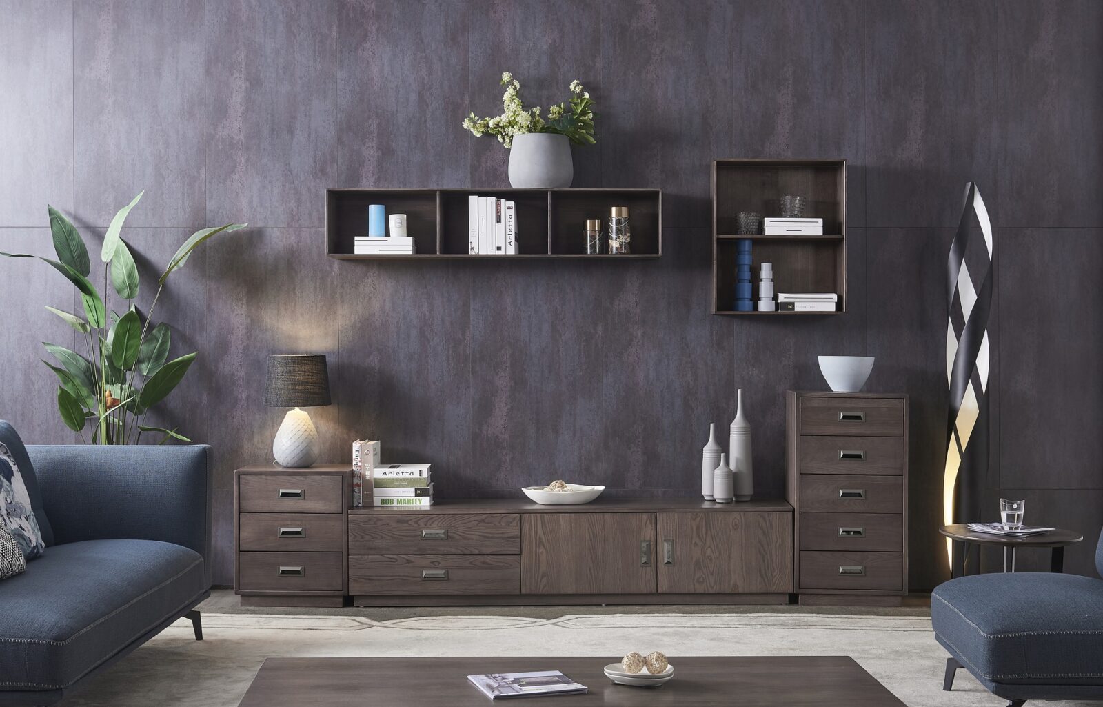 dark-hued living room wall with hanging cabinetry and blue couch