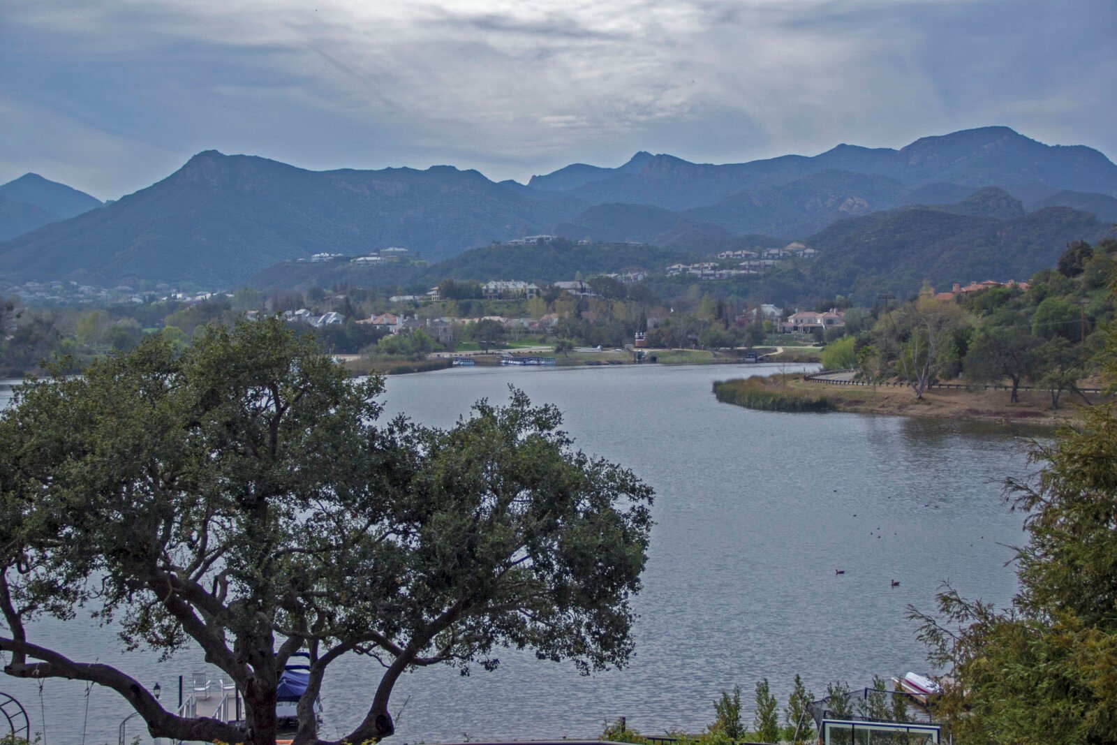 panoramic view of lake sherwood in westlake village, california, with mountains in the background