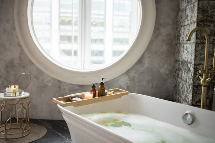 bathtub with circular window in the background