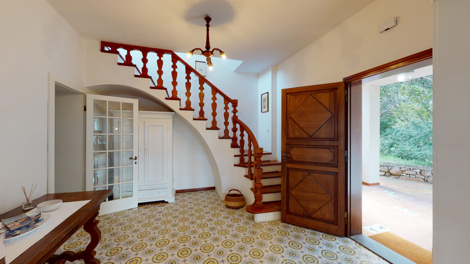 interior view of the home with white walls and a large staircase