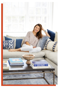 Kathy sitting on a couch, smiling and relaxed.
