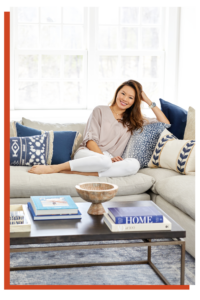 Kathy sitting on a couch, smiling and relaxed. 