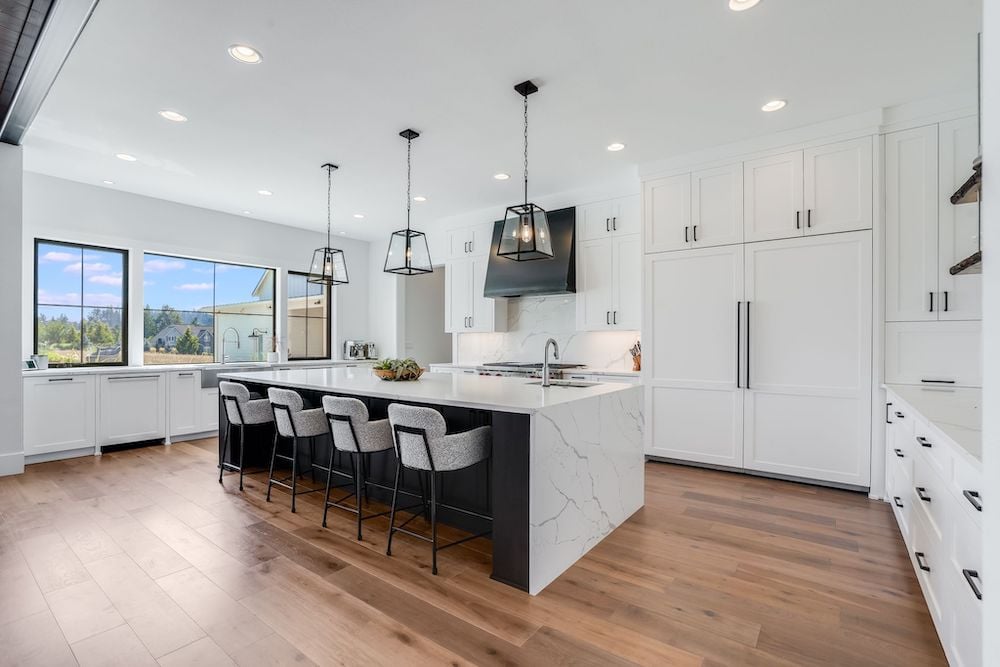 interior view of a kitchen with matching backsplash and kitchen island