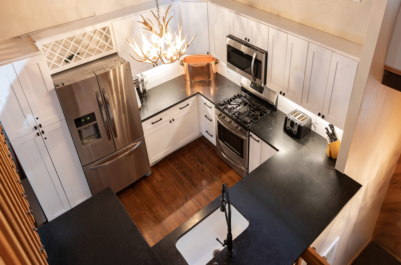 overhead view of a cozy kitchen with black accent details. 