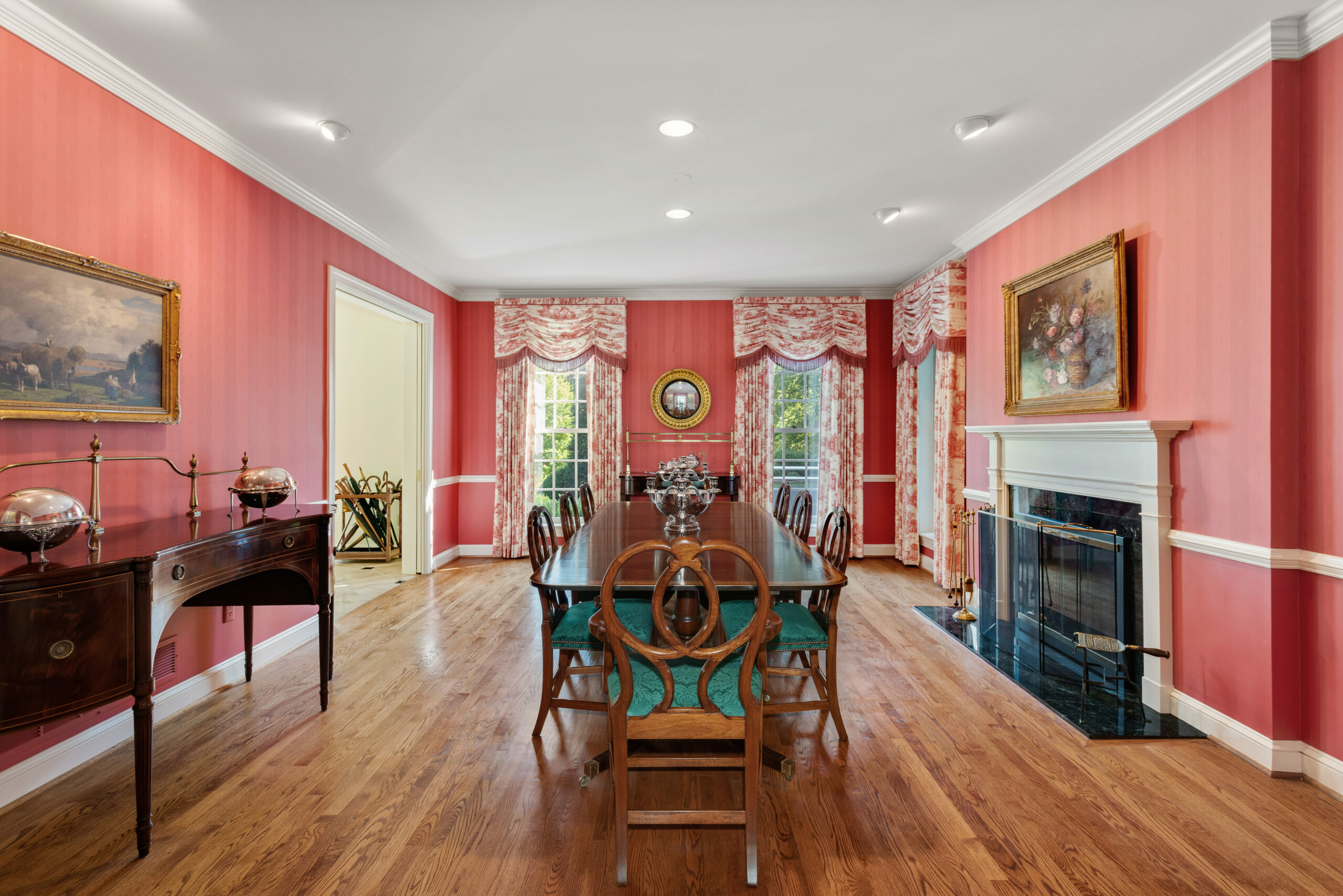 interior view of the dining room with lovely red walls and wood flooring