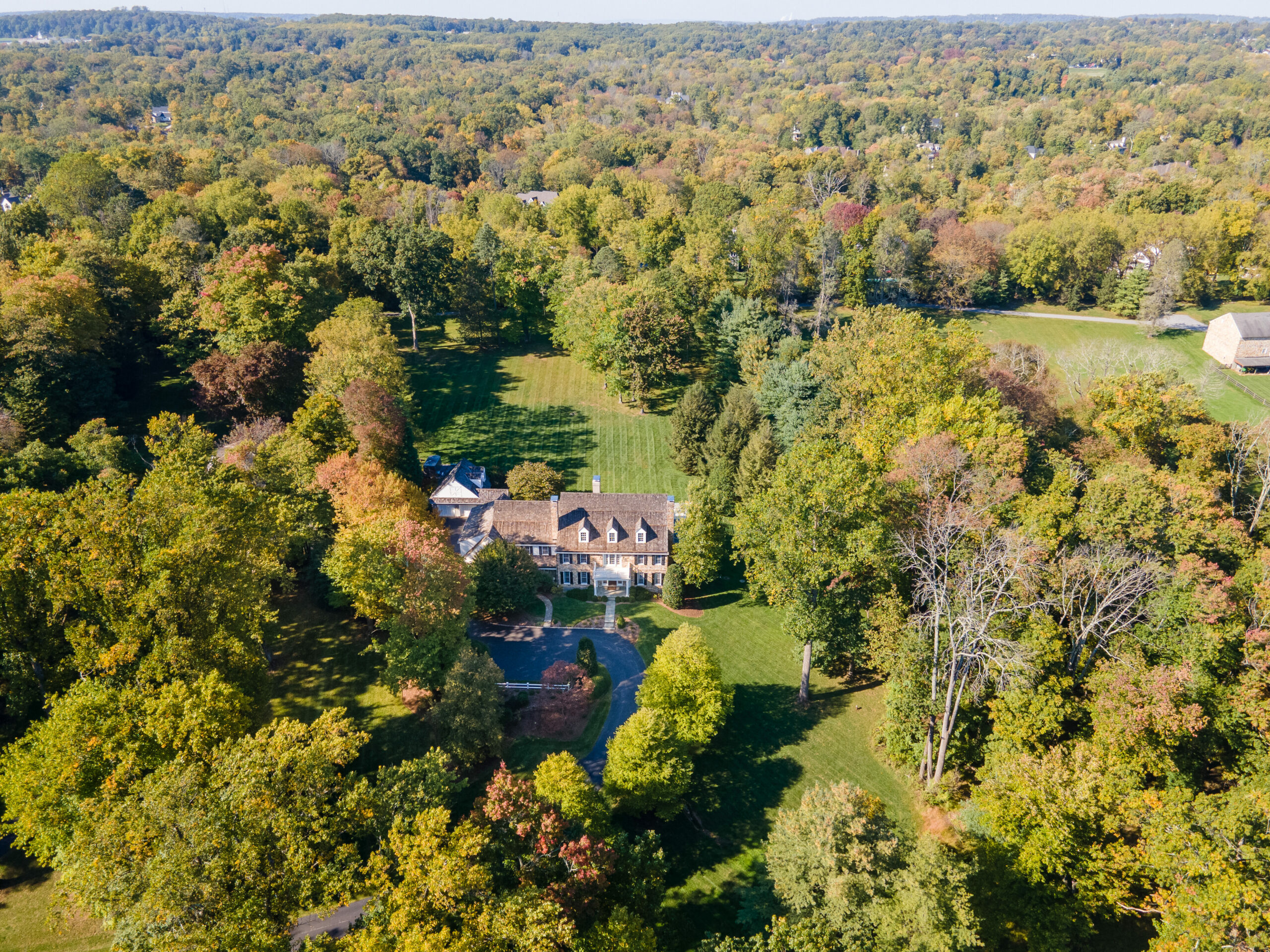 aerial view of the home and surrounding trees