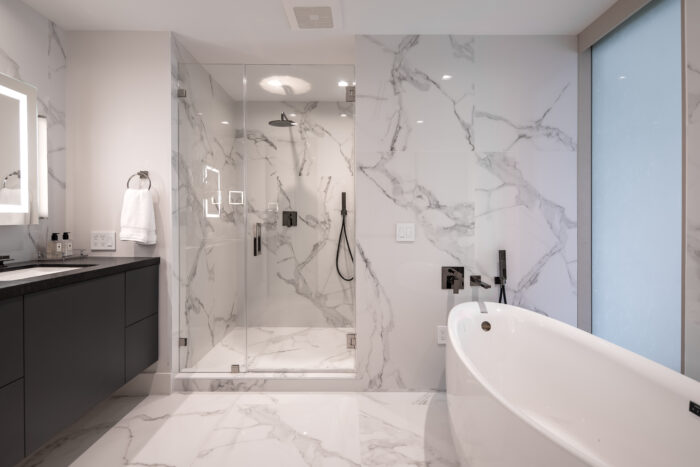 Interior view of a bathroom with white marble throughout