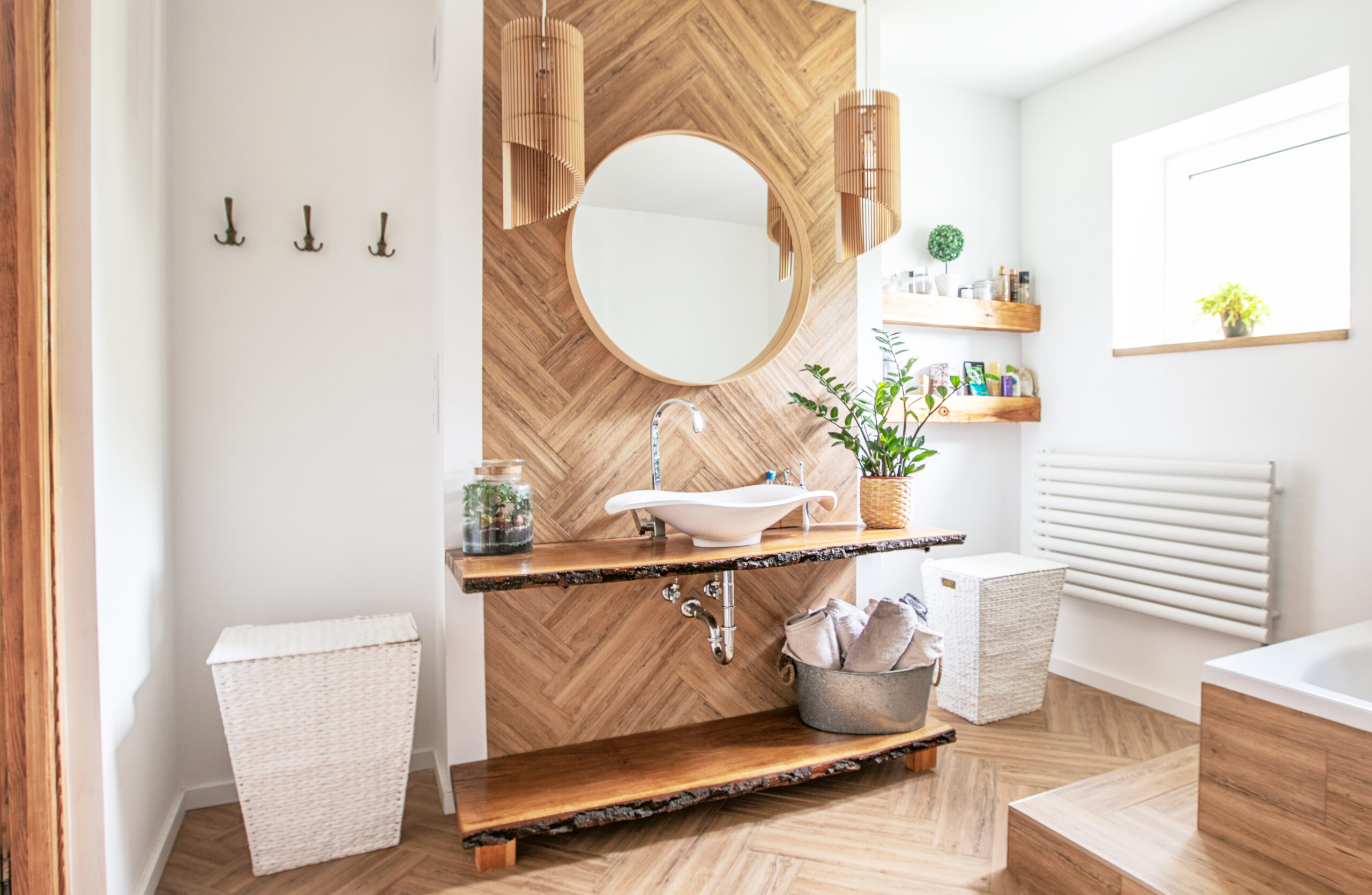 Luxury Bathroom With Round Mirror And Wood Backsplash