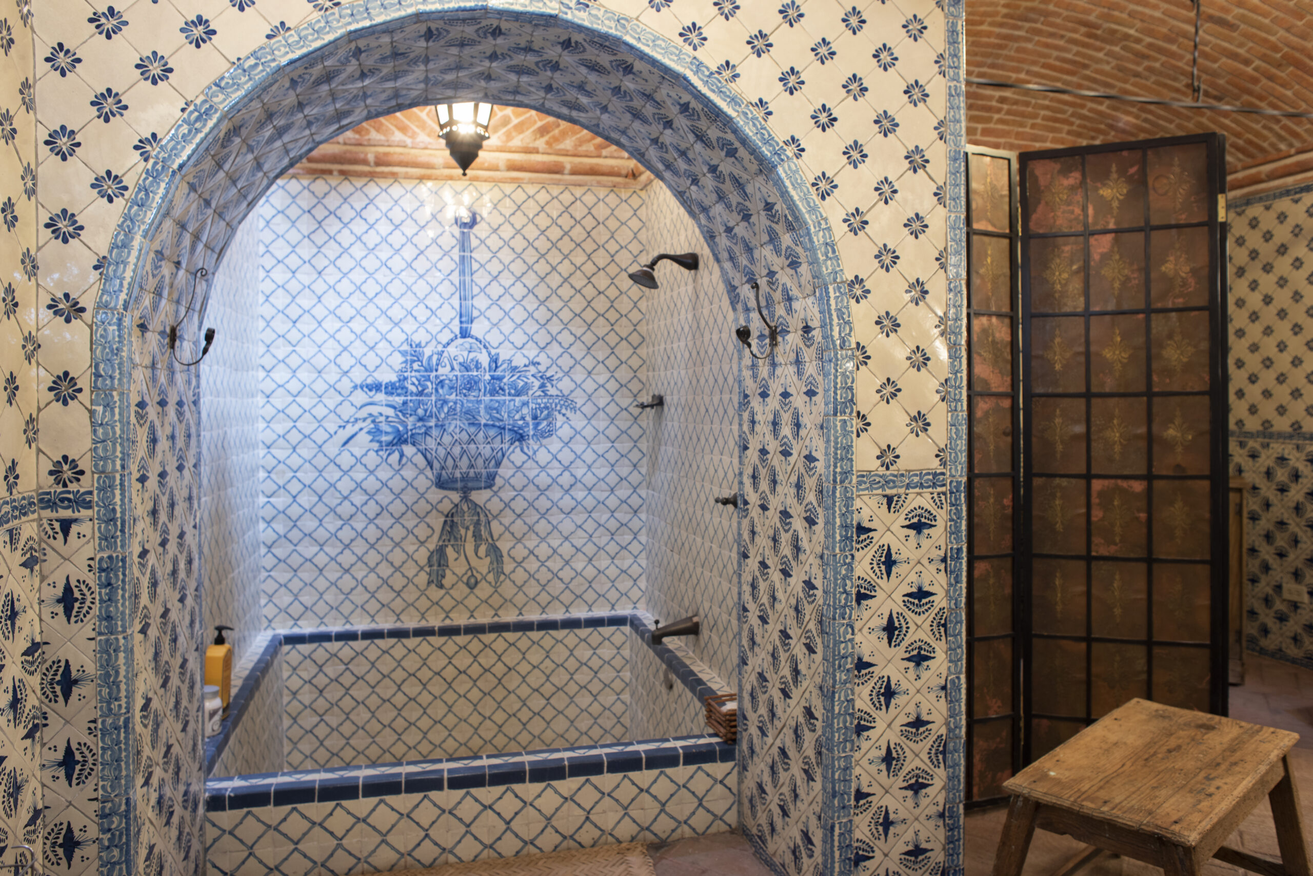 Interior view of a bathroom with intricate blue tiling. 