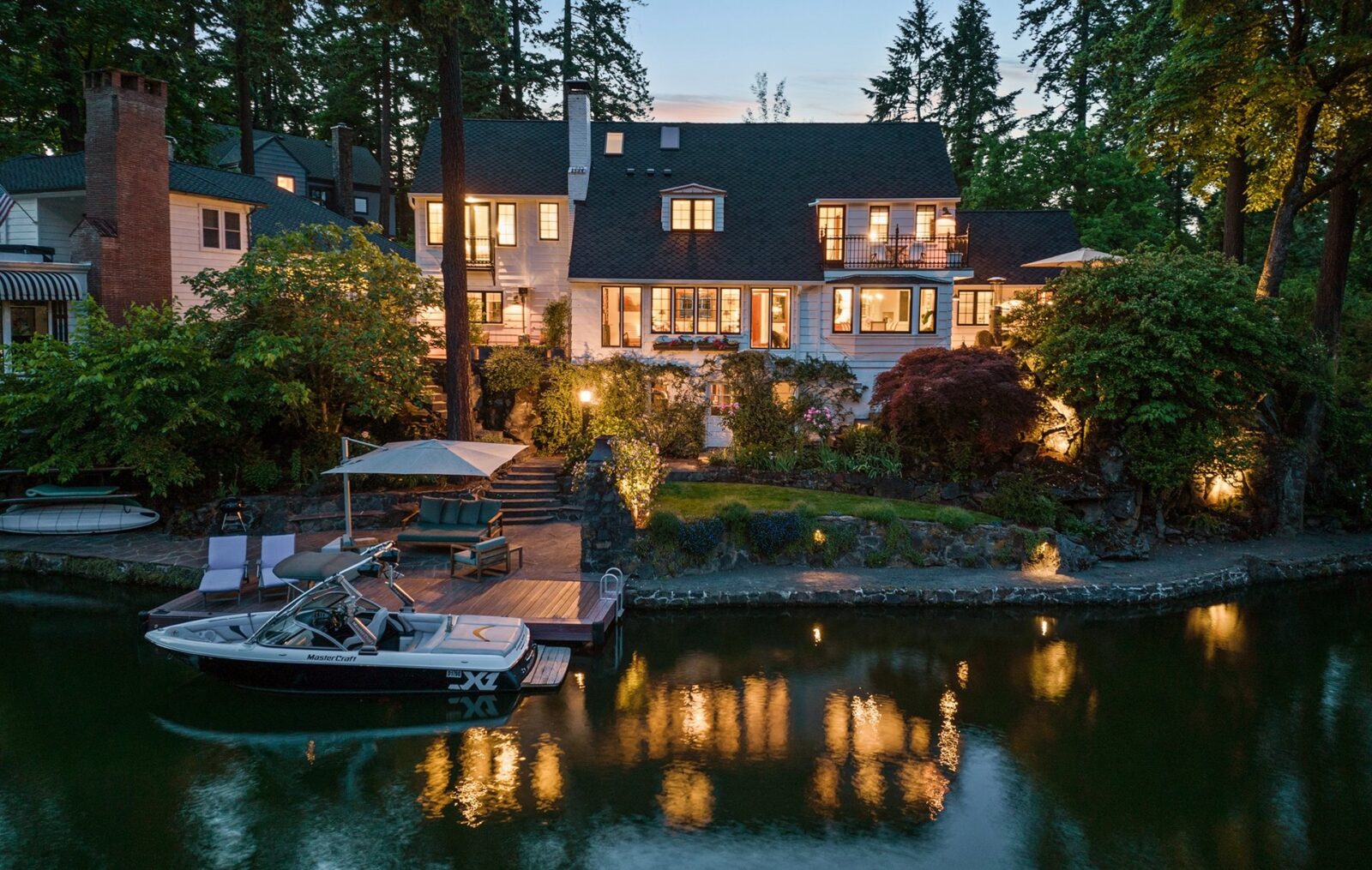 Lakeside Home With Lights On At Night
