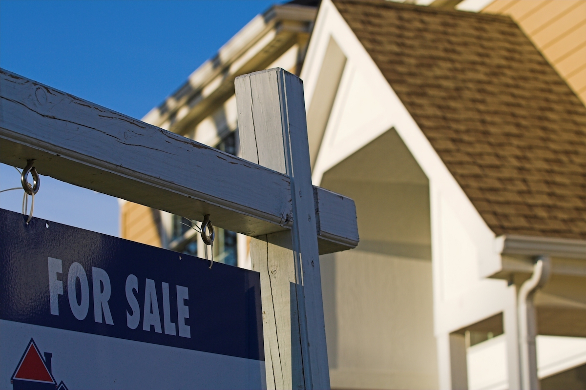 Home with 'For Sale' sign