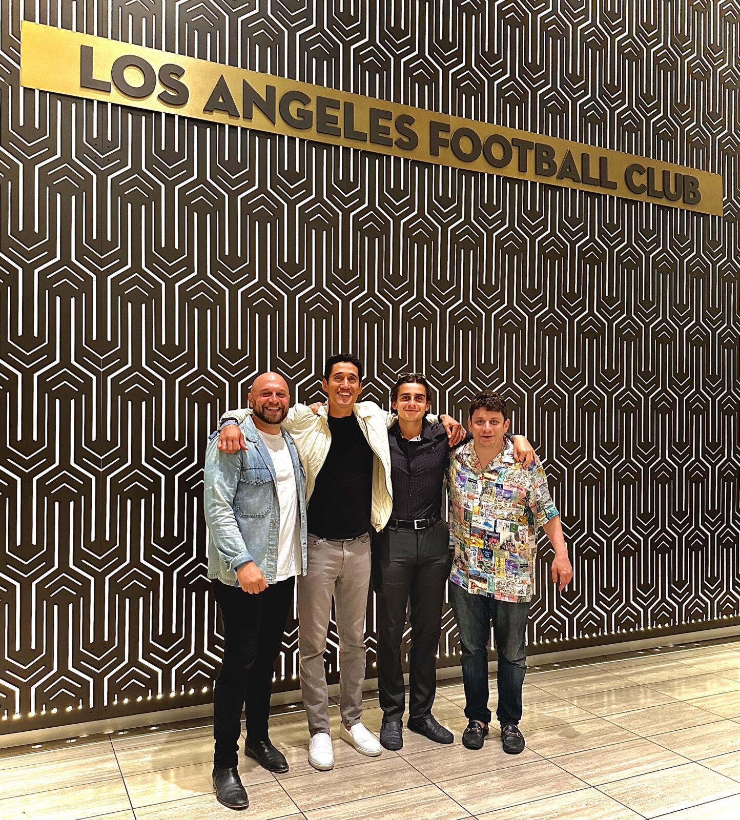 Paul Salazar Group Photo In Front Of Los Angeles Football Club Sign