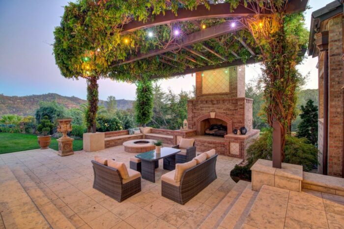 Outdoor Fireplace Sitting Area With Arbor Trellis