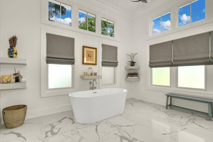 A spacious bathroom with marble flooring. 