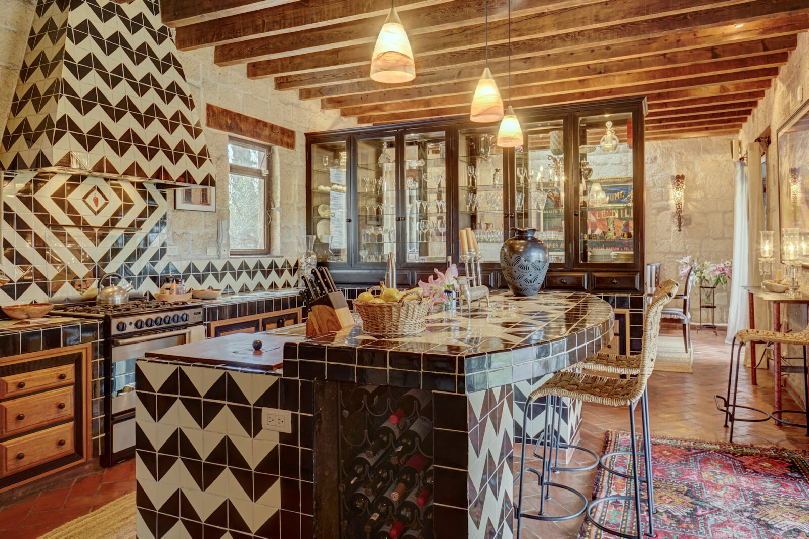 Elaborate tiling and wood beams in San Miguel home kitchen.