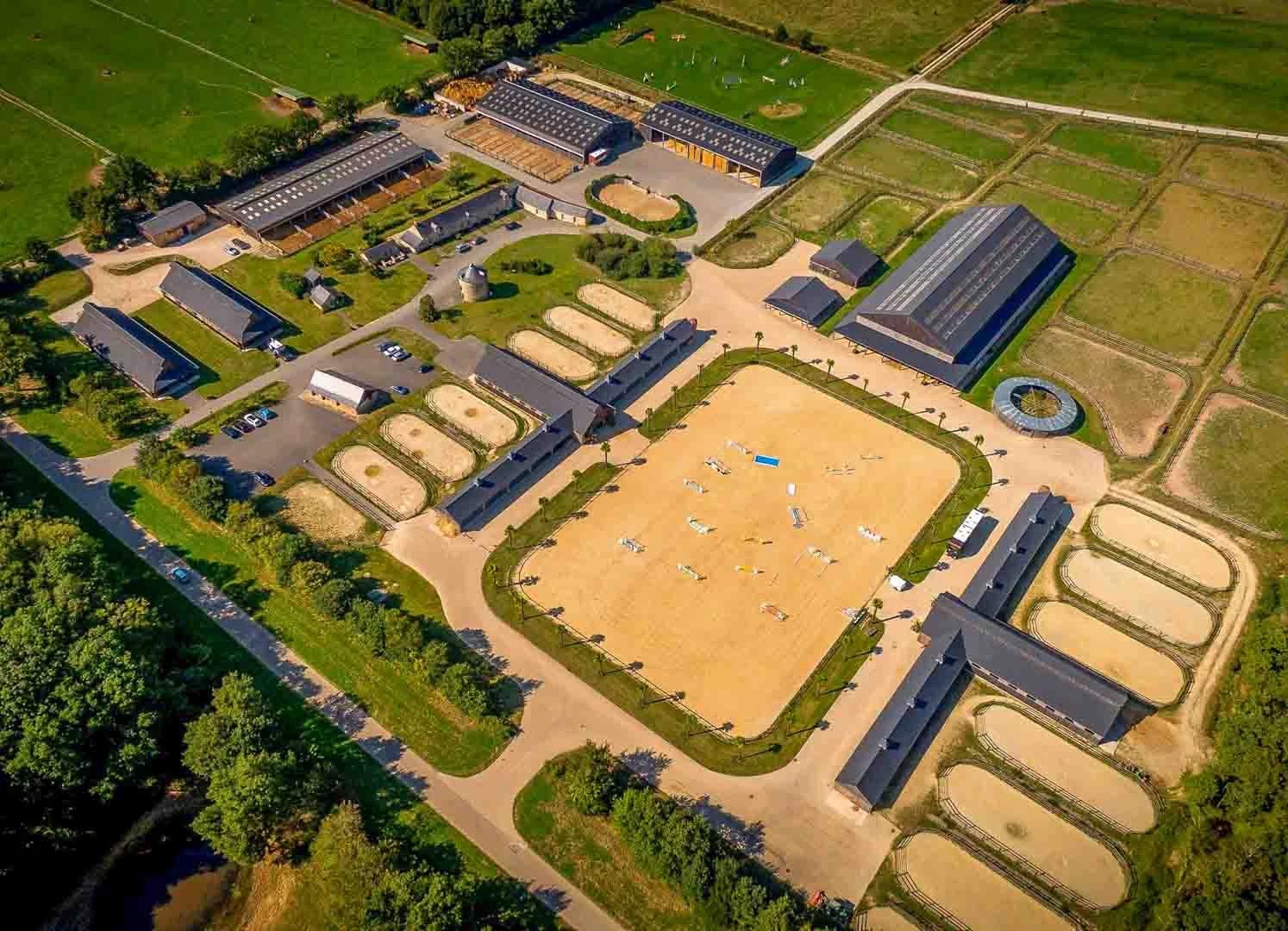 Birds eye view of French estate with equestrian facilities.