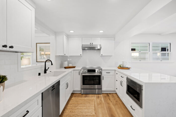 An open-concept kitchen with quartz countertops. 