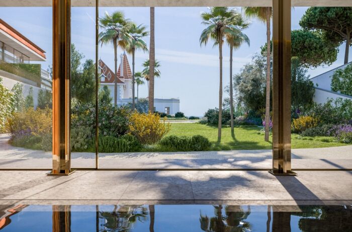 Sleek indoor pool with floor-to-ceiling glass doors. 