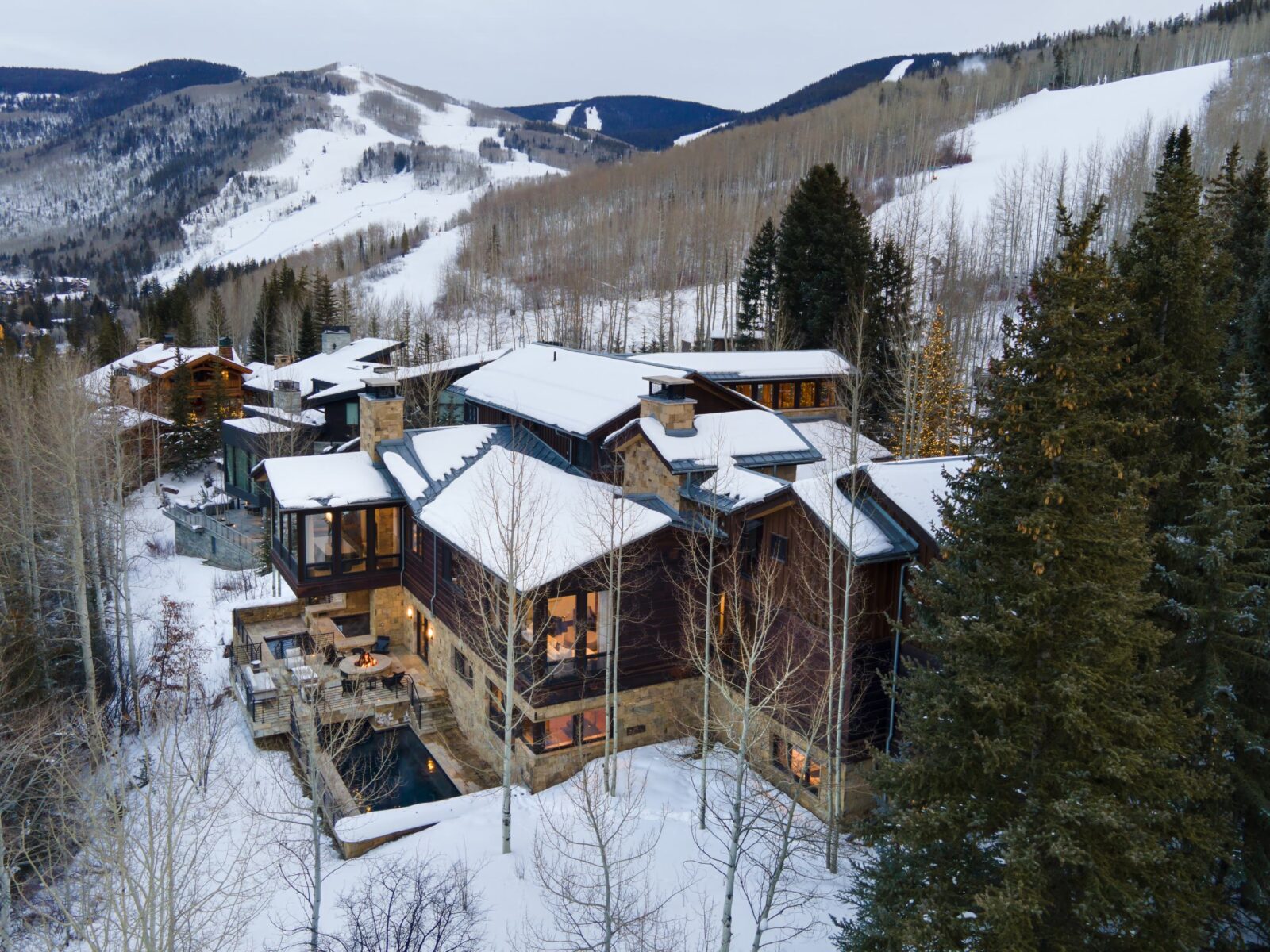 Bird's eye view of luxury estate in Vail Village with mountain backdrop. 