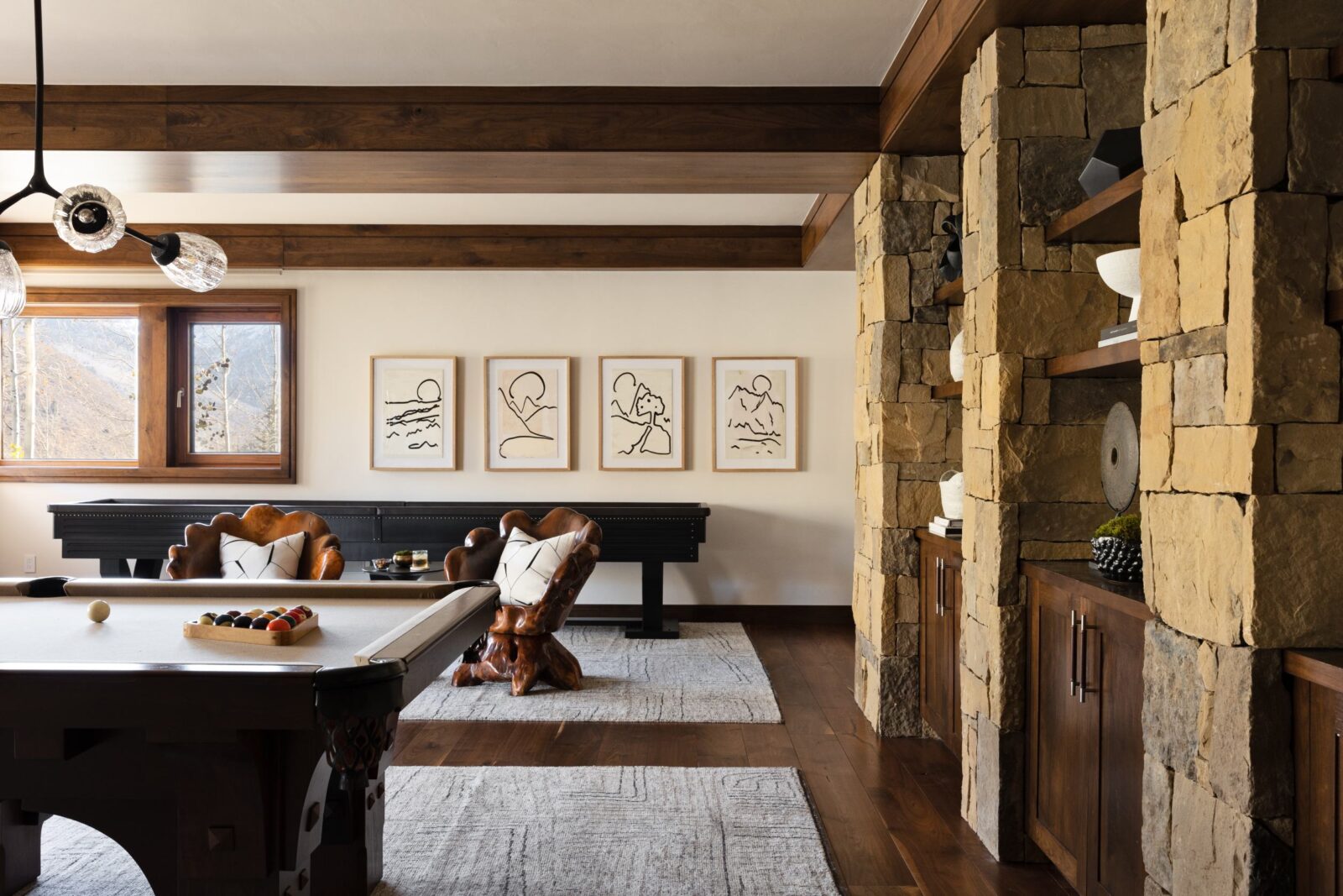 Billiards table at the center of sleek gaming room. 