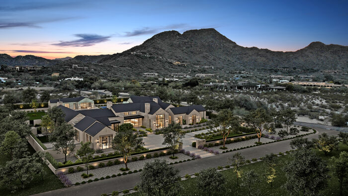 A big mansion on dry Arizona land at the foot of a mountain.