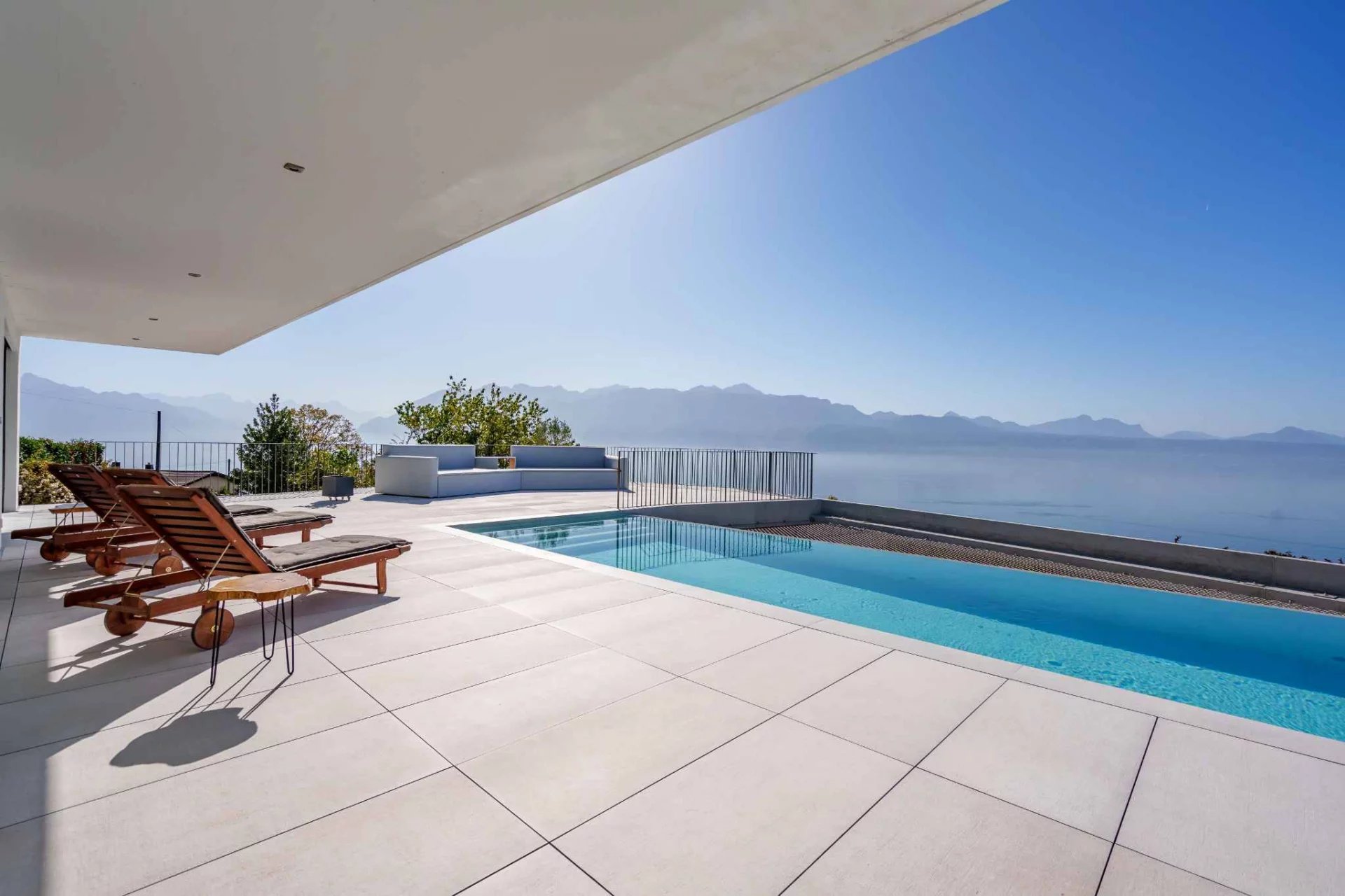 Contemporary terrace with pool overlooking Lake Geneva