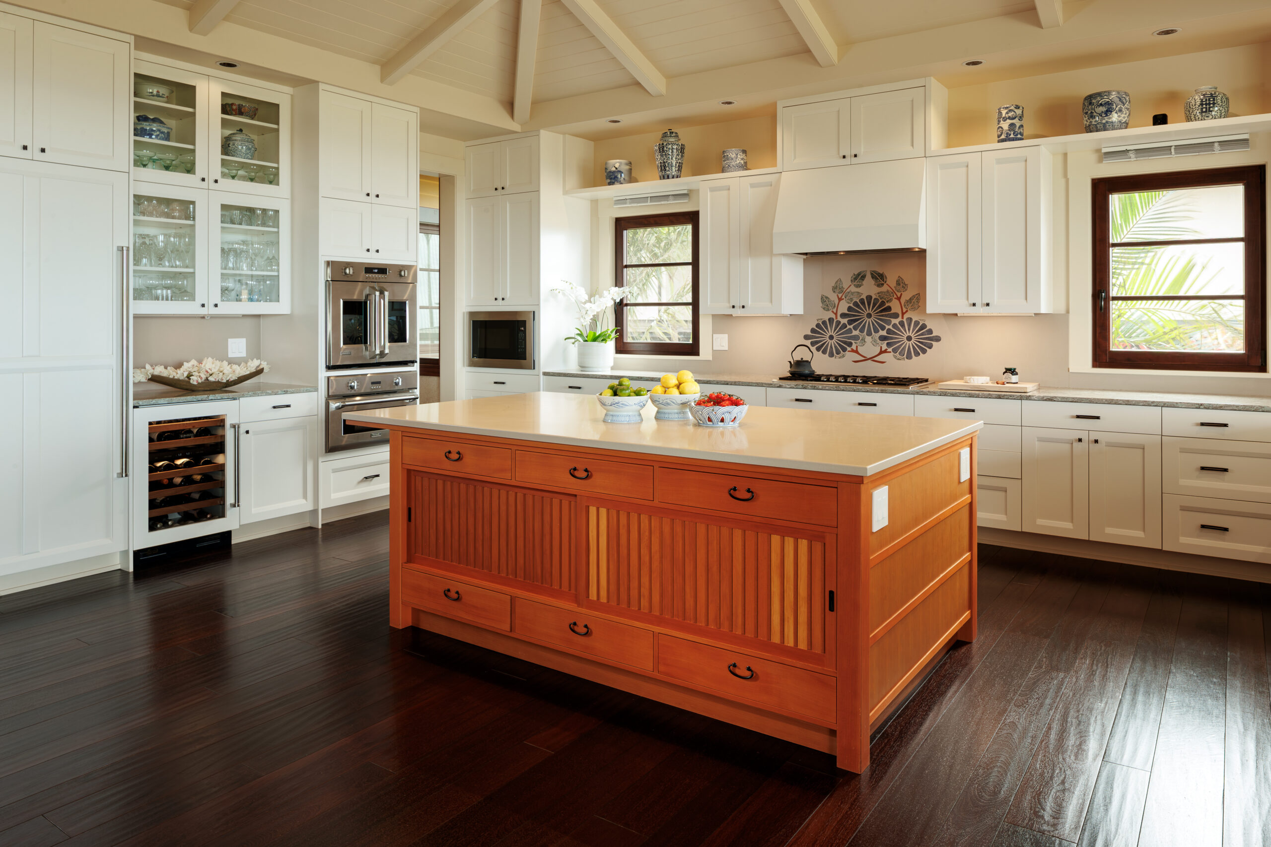 Spacious kitchen with large central island and shaker-style cabinetry. 
