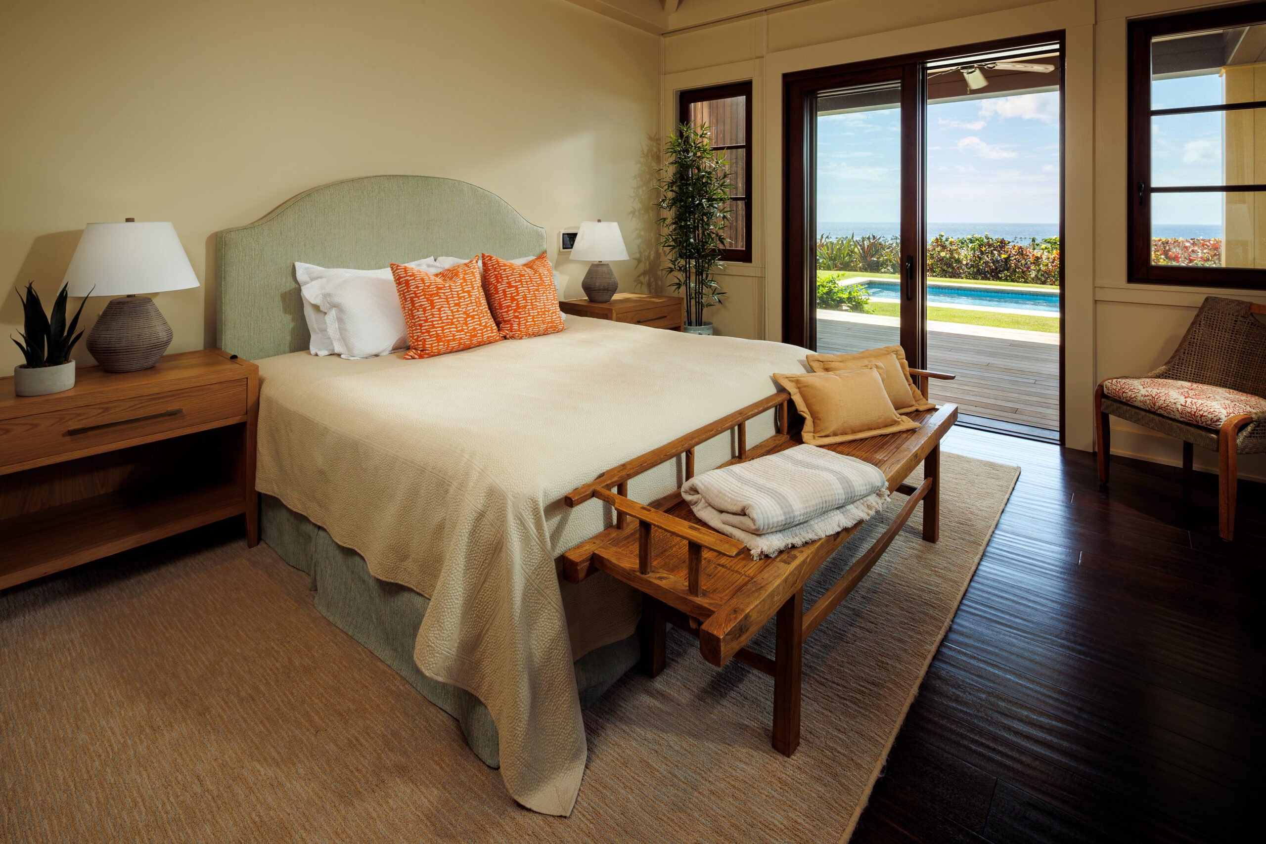Hawaii estate bedroom with sliding glass door leading out to deck. 